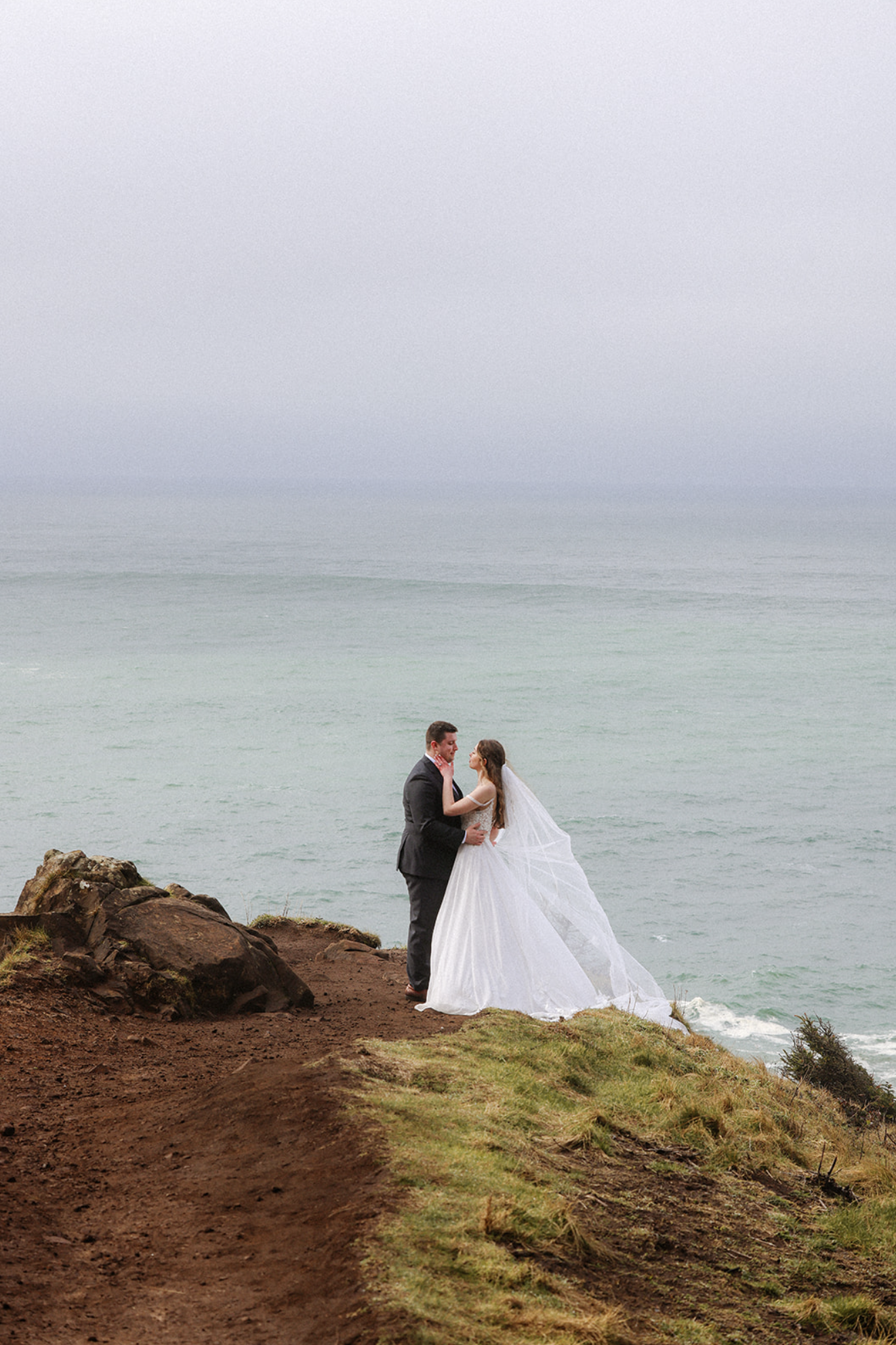 Bride and groom eloping on the cliffs at Elk Flats, Oregon with ocean views and dramatic coastal landscape